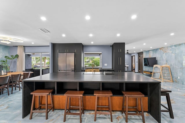 1772 SW Commodore Pl, Palm City, FL 34990 - kitchen featuring stainless steel fridge, modern cabinets, a spacious island, recessed lighting, and plenty of natural light