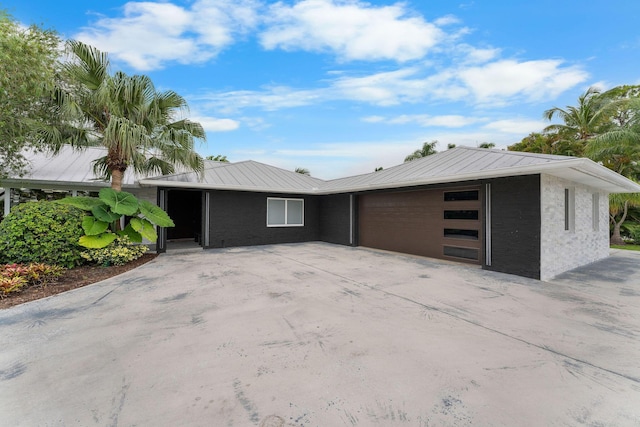 1772 SW Commodore Pl, Palm City, FL 34990 - view of front of home with a garage, metal roof, concrete driveway, and brick siding