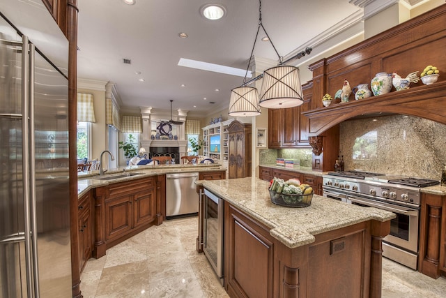 7656 Steeplechase Dr, Palm Beach Gardens, FL 33418 - kitchen featuring high end appliances, a sink, a fireplace, crown molding, and backsplash