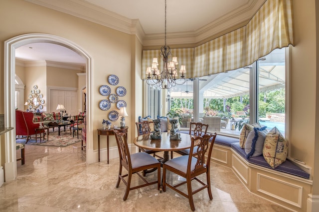 7656 Steeplechase Dr, Palm Beach Gardens, FL 33418 - dining room featuring ornamental molding, arched walkways, a chandelier, a decorative wall, and wainscoting
