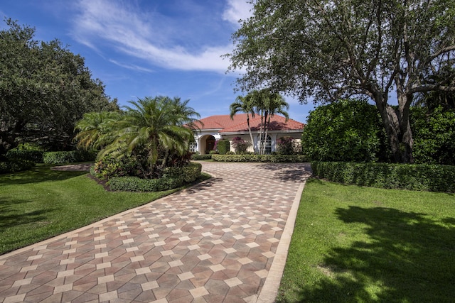 7656 Steeplechase Dr, Palm Beach Gardens, FL 33418 - view of community with decorative driveway and a yard
