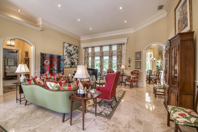 7656 Steeplechase Dr, Palm Beach Gardens, FL 33418 - living area with arched walkways, wainscoting, crown molding, a decorative wall, and marble tiled floors