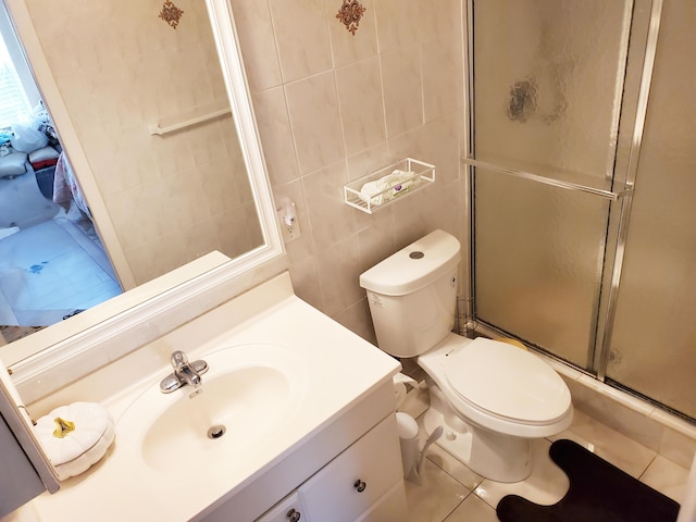 708 Laconia Cir Unit 708, Lake Worth, FL 33467 - bathroom featuring tile walls, a stall shower, vanity, toilet, and tile patterned floors