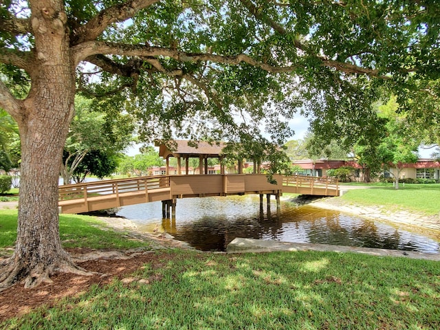 708 Laconia Cir Unit 708, Lake Worth, FL 33467 - dock area featuring a lawn and a water view