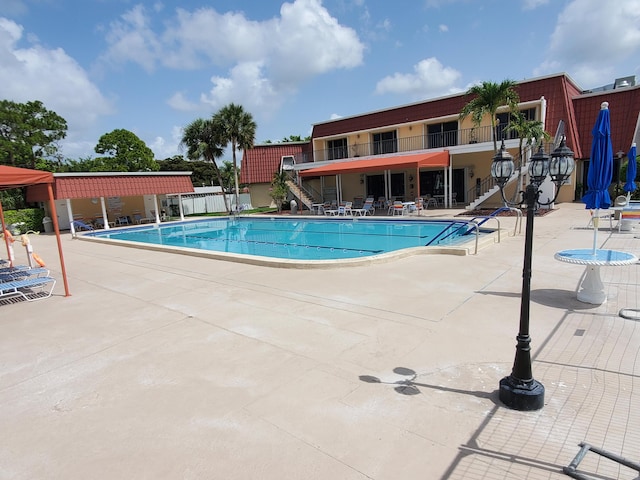 708 Laconia Cir Unit 708, Lake Worth, FL 33467 - community pool featuring stairs and a patio area
