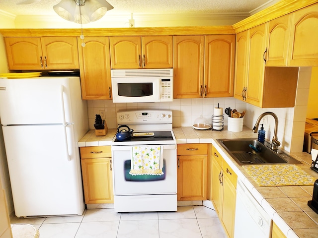 708 Laconia Cir Unit 708, Lake Worth, FL 33467 - kitchen with white appliances, tile countertops, a sink, crown molding, and backsplash