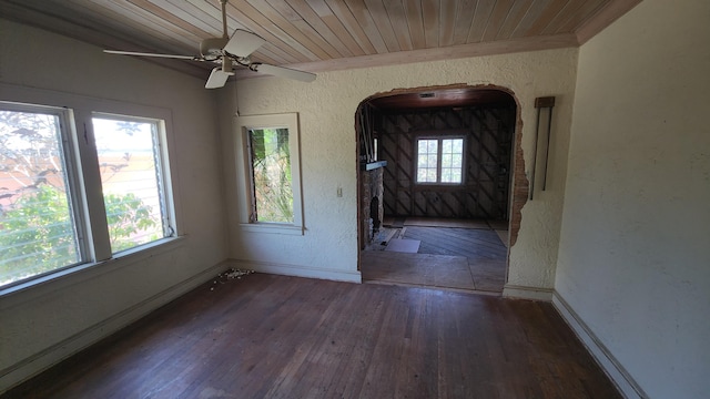 1709 N Palmway, Lake Worth Beach, FL 33460 - unfurnished dining area featuring a textured wall, wood-type flooring, baseboards, wooden ceiling, and a ceiling fan