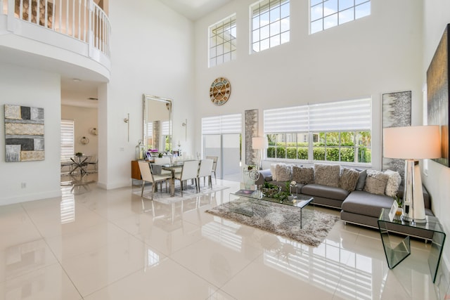 1522 Carafe Ct, Palm Beach Gardens, FL 33410 - tiled living area featuring a high ceiling, healthy amount of natural light, and baseboards