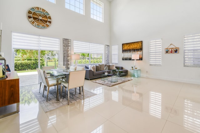 1522 Carafe Ct, Palm Beach Gardens, FL 33410 - dining space with a towering ceiling, tile patterned flooring, and baseboards