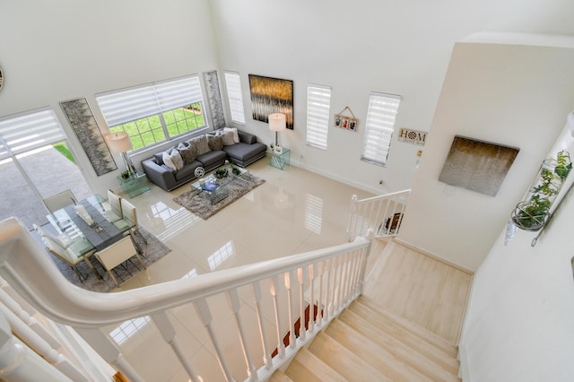 1522 Carafe Ct, Palm Beach Gardens, FL 33410 - staircase featuring a towering ceiling and baseboards