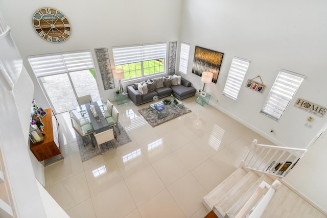 1522 Carafe Ct, Palm Beach Gardens, FL 33410 - tiled living area featuring a high ceiling and baseboards