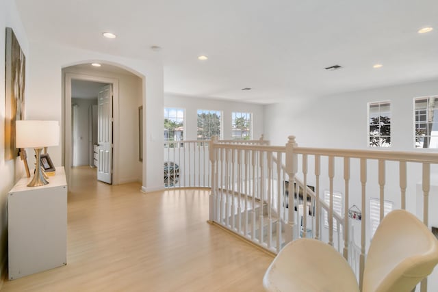 1522 Carafe Ct, Palm Beach Gardens, FL 33410 - hallway featuring recessed lighting, light wood-style floors, baseboards, and arched walkways