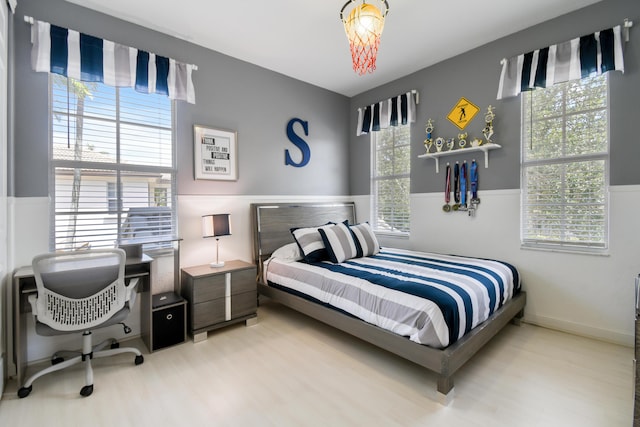1522 Carafe Ct, Palm Beach Gardens, FL 33410 - bedroom with wood finished floors, an office area, and a wainscoted wall