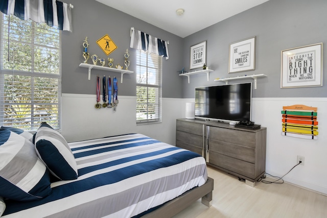 1522 Carafe Ct, Palm Beach Gardens, FL 33410 - bedroom with wood finished floors and wainscoting