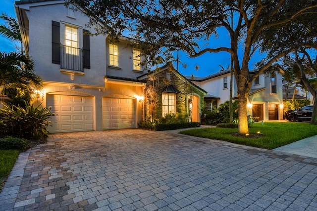 1522 Carafe Ct, Palm Beach Gardens, FL 33410 - view of front of house featuring decorative driveway, a garage, stucco siding, and a front lawn