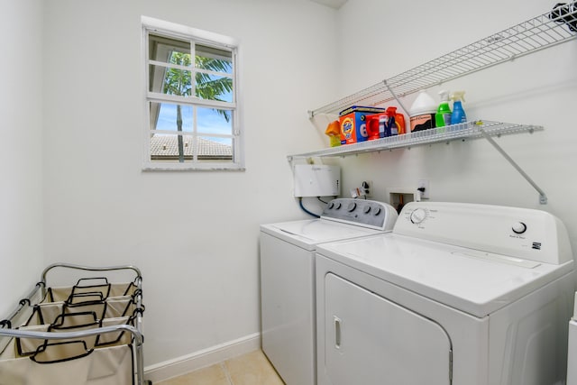 1522 Carafe Ct, Palm Beach Gardens, FL 33410 - laundry room with washing machine and clothes dryer, baseboards, and light tile patterned flooring