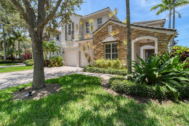 1522 Carafe Ct, Palm Beach Gardens, FL 33410 - mediterranean / spanish home with stone siding, stucco siding, an attached garage, and decorative driveway
