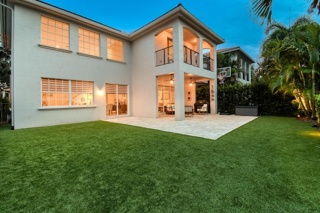 1522 Carafe Ct, Palm Beach Gardens, FL 33410 - rear view of property featuring a balcony, stucco siding, a patio, and a yard