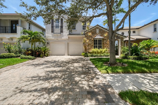 1522 Carafe Ct, Palm Beach Gardens, FL 33410 - mediterranean / spanish house with stucco siding, decorative driveway, and a garage