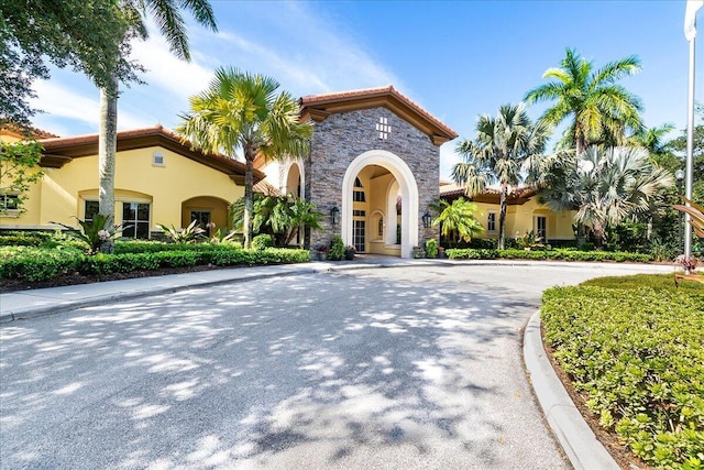 1522 Carafe Ct, Palm Beach Gardens, FL 33410 - view of front of house with stucco siding, stone siding, and a tile roof