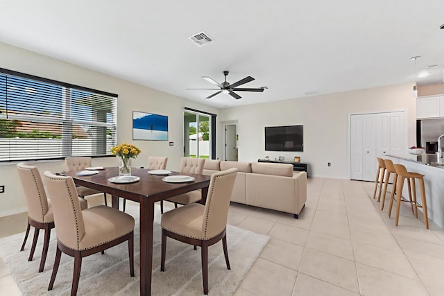 6700 NW Omega Rd, Port Saint Lucie, FL 34983 - dining area with light tile patterned floors, a ceiling fan, and baseboards