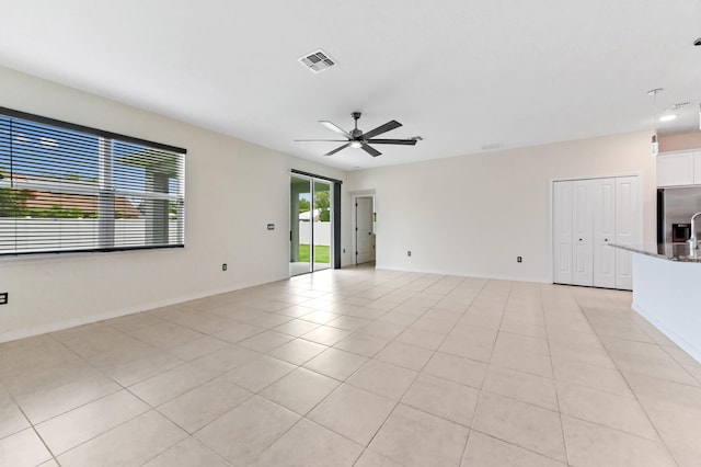 6700 NW Omega Rd, Port Saint Lucie, FL 34983 - spare room featuring ceiling fan, baseboards, and light tile patterned flooring