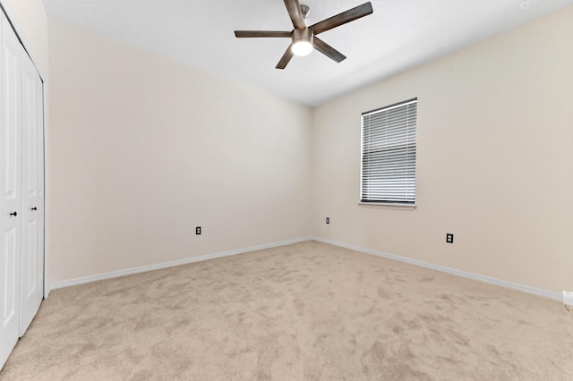 6700 NW Omega Rd, Port Saint Lucie, FL 34983 - unfurnished bedroom with light carpet, a closet, baseboards, and a ceiling fan