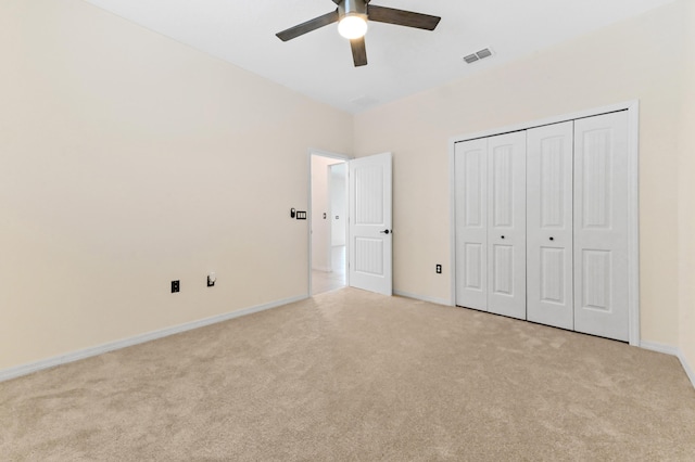 6700 NW Omega Rd, Port Saint Lucie, FL 34983 - unfurnished bedroom featuring light carpet, baseboards, a closet, and ceiling fan