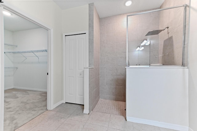 6700 NW Omega Rd, Port Saint Lucie, FL 34983 - full bathroom with walk in shower, baseboards, tile patterned flooring, recessed lighting, and a spacious closet