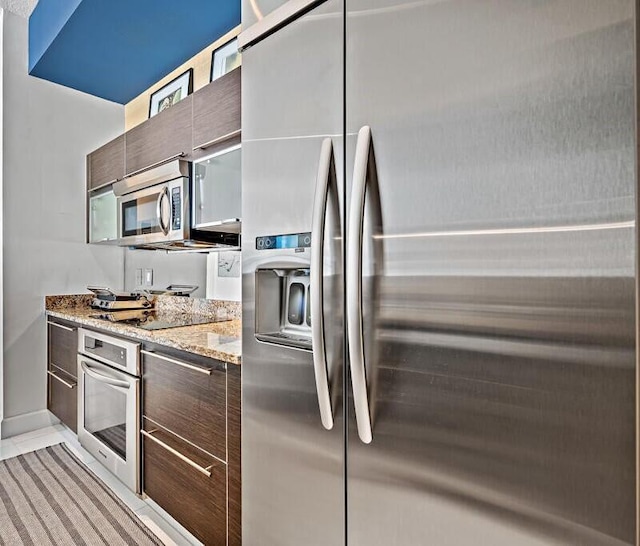 550 Okeechobee Blvd Unit Uph-15, West Palm Beach, FL 33401 - kitchen with appliances with stainless steel finishes, modern cabinets, light stone counters, and dark brown cabinetry