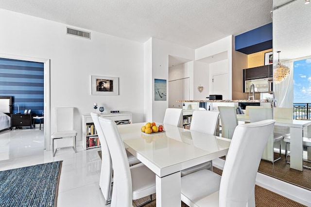 550 Okeechobee Blvd Unit Uph-15, West Palm Beach, FL 33401 - dining space with a textured ceiling