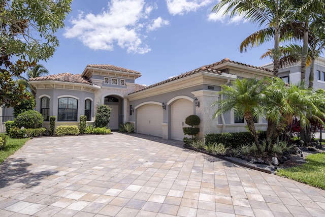 9759 Vitrail Ln, Delray Beach, FL 33446 - mediterranean / spanish-style home with a tiled roof, a garage, decorative driveway, and stucco siding