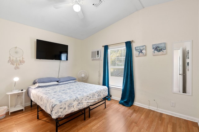 716 21st St, West Palm Beach, FL 33407 - bedroom with vaulted ceiling, light wood-type flooring, baseboards, a wall mounted AC, and ceiling fan