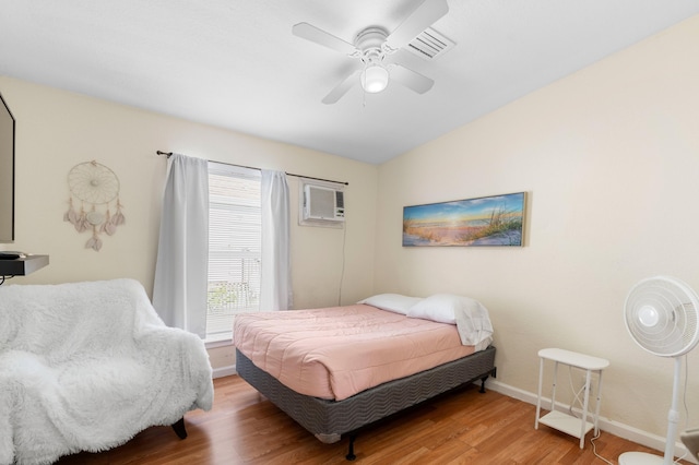 716 21st St, West Palm Beach, FL 33407 - bedroom with a wall mounted AC, wood finished floors, baseboards, and a ceiling fan