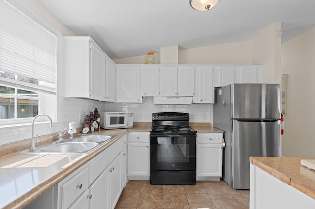 716 21st St, West Palm Beach, FL 33407 - kitchen featuring black electric range, freestanding refrigerator, white microwave, under cabinet range hood, and a sink
