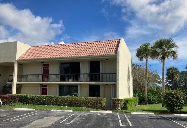 2520 Presidential Way Unit 205, West Palm Beach, FL 33401 - view of property featuring uncovered parking