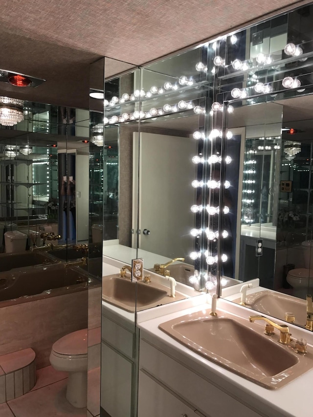 2520 Presidential Way Unit 205, West Palm Beach, FL 33401 - full bathroom featuring toilet, vanity, a bath, and tile patterned floors