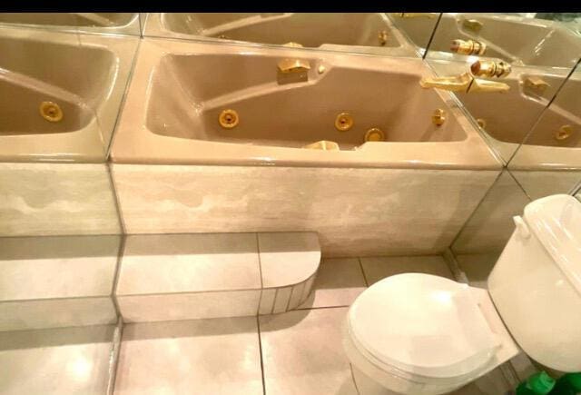 2520 Presidential Way Unit 205, West Palm Beach, FL 33401 - full bath featuring tile patterned flooring, a tub with jets, and toilet