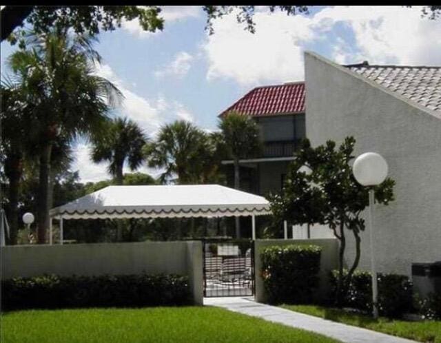 2520 Presidential Way Unit 205, West Palm Beach, FL 33401 - view of home's community featuring a fenced front yard and a gate
