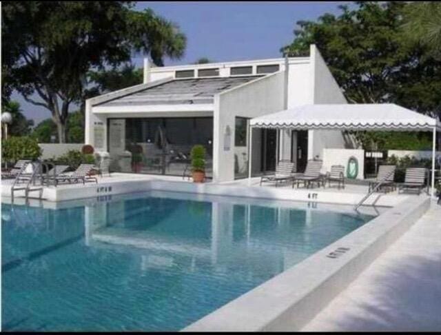 2520 Presidential Way Unit 205, West Palm Beach, FL 33401 - community pool featuring a patio
