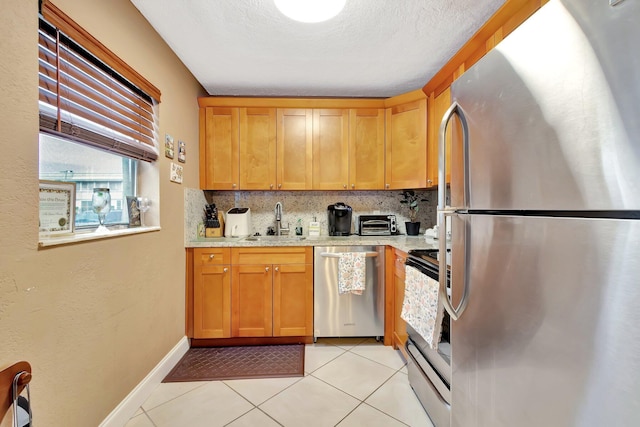 637 N Monaco N Unit 637, Delray Beach, FL 33446 - kitchen with appliances with stainless steel finishes, a sink, tasteful backsplash, light tile patterned floors, and baseboards