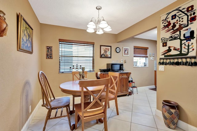 637 N Monaco N Unit 637, Delray Beach, FL 33446 - dining room with a chandelier, plenty of natural light, light tile patterned floors, and baseboards