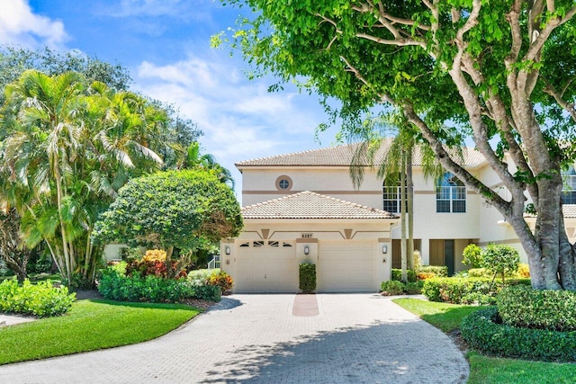 6357 Graycliff Dr Unit C, Boca Raton, FL 33496 - view of front facade featuring stucco siding, an attached garage, decorative driveway, and a tiled roof