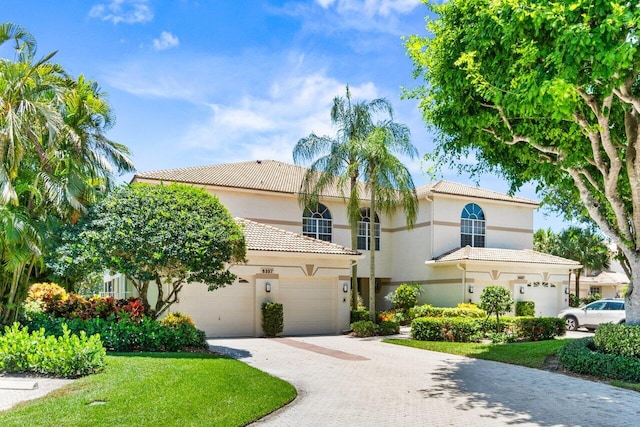 6357 Graycliff Dr Unit C, Boca Raton, FL 33496 - mediterranean / spanish home with driveway, a tile roof, stucco siding, and an attached garage