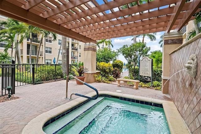 1801 N Flagler Dr Unit 622, West Palm Beach, FL 33407 - view of swimming pool with a community hot tub and a pergola