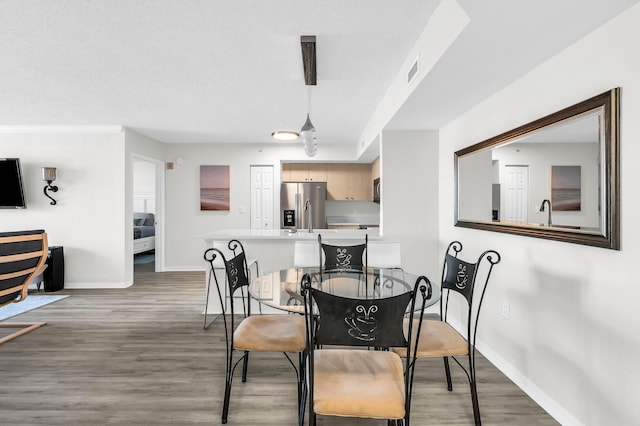 1801 N Flagler Dr Unit 622, West Palm Beach, FL 33407 - dining area with baseboards and light wood-style flooring