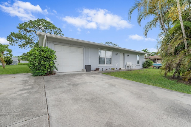 590 SE Anchor Ln, Port Saint Lucie, FL 34983 - ranch-style house featuring concrete driveway, an attached garage, and a front yard