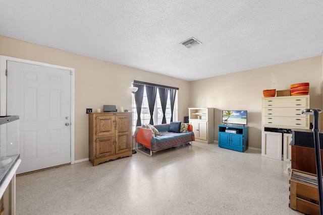 590 SE Anchor Ln, Port Saint Lucie, FL 34983 - living area featuring speckled floor and a textured ceiling
