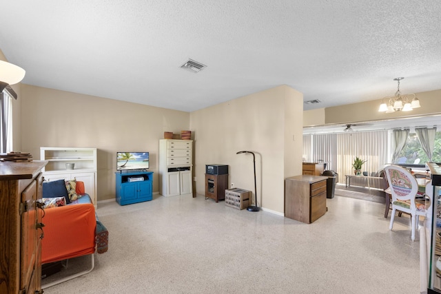 590 SE Anchor Ln, Port Saint Lucie, FL 34983 - living area featuring a chandelier, a textured ceiling, and speckled floor