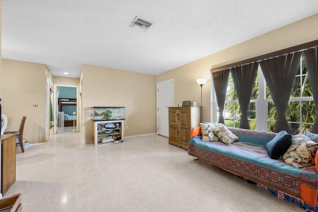 590 SE Anchor Ln, Port Saint Lucie, FL 34983 - living area featuring speckled floor and a textured ceiling
